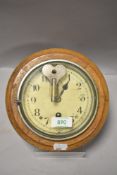 20th century button form clock having oak case and key