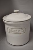 A white glazed earthen ware bread crock.