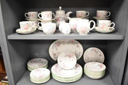 A 20th century Royal Doulton dinner and breakfast service over two shelfs in the Expressions