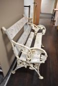 A Victorian Coalbrookdale style two seater garden bench having ivy leaf and foliate cast ends
