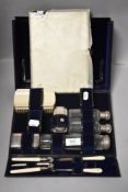 An Edwardian gentleman dress set including cut glass containers in fitted case
