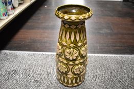 A large vintage West German vase having green glaze with exposed ceramic moulded floral and