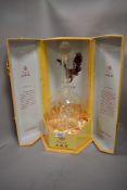 A 20th century Chinese Wuliangye bottle with case having encased glass eagle