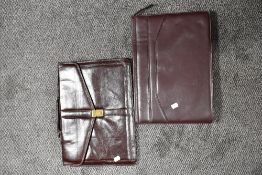 Two Burgundy brief cases, one labelled 'Salisbury'.