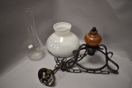 A 20th century ceiling mounted light fitting in an oil lamp design
