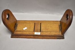 An Edwardian extending fold away bookshelf in oak