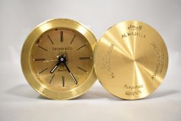 A 20th century portable pocket size clock or watch by Tiffany having brass case and Arabic inscribed