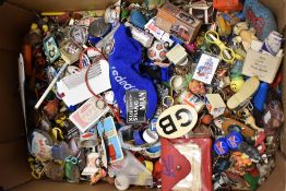 A box full of retro collectable key rings and similar.