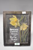 A Victorian era school slate decorated with daffodil and Hawkshead Grammar school