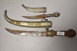 Two possibly Middle Eastern Khanjar, total length 20cm, highly decorated white metal scabbard and
