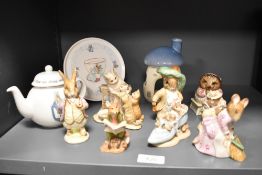 A selection of 20th century Beatrix Potter figures and ceramics including Wedgwood teapot