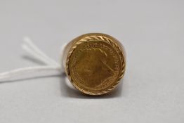 A gold plated ring with copy gold coin decoration