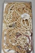 A tray of pearl style neclaces