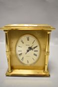 A Swiza mid century mantle clock having brass case