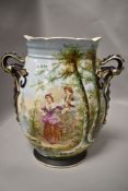 A porcelain mantle vase having hand painted decoration of two 18th century lovers with landscape