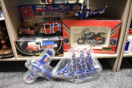 A collection of retro Pepsi themed toys including planes, bike and car.