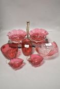 A selection of cranberry glass to include bon bon dishes in plated holder, bowls, jug and more.