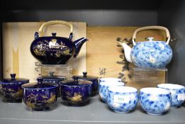 Two 20th century Chinese tea sets one cobalt blue and gold and blue ground with flowers both