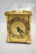 A vintage smiths mantel clock having roman numerals to face and etched designs to face and sides,