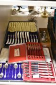 Four boxes of vintage cutlery including engraved MOP handled knives and forks having engraved detail