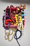 A box of costume beads and necklaces