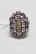 An oversized amethyst and marcasite multi stone ring of artisan form on a white metal loop stamped