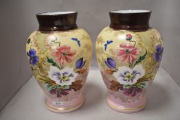A pair of late Victorian glass vase having mirrored decoration of flowers on pink ground