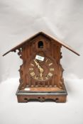 An early 20th century oak case cuckoo clock