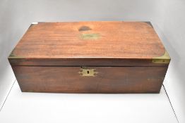 A Victorian mahogany writing slope with brass brackets and details, having green baize lining and