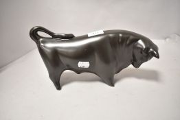 A 20th century Trentham pottery figure study of a bull in matt black