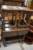 A traditional dark stained Priory style tea trolley and two similar occasional tables