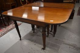 A 19th Century Regency design mahogany extending dining table in the Gillows style having four