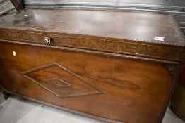 An Edwardian bedding box having oak frame with carved details