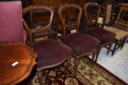 Three Victorian dining chairs having mahogany frames fluted legs with carved balloon style backs