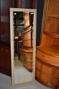 A modern dressing mirror having gesso style frame