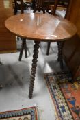 An Edwardian cricket style table having turned bobbin style feet