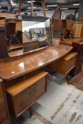 A mid century G Plan dressing table with mirror back, and two matching chest of drawers