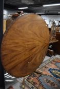 A Victorian tilt top dining pedestal table having had alterations
