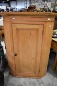 A 19th Century stripped pine corner cupboard of large proportions