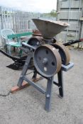 A vintage belt driven grain roller