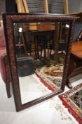 A modern mirror with carved floral frame work