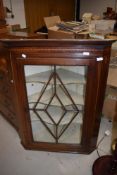 Victorian corner cupboard having astral glazed front with inlayed decoration