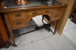 An early 20th century Sheraton style writing desk having shelf and cupboard back with fitted