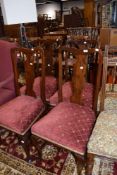 A set of four mahogany vase back dining chairs having Queen Anne style legs and turned h stretchers