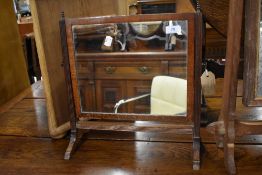A Regency style toilet mirror having fluted mahogany frame with carved legs