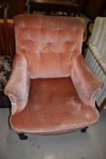 An early 20th century lounge chair having turned legs