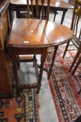 An Edwardian golden oak drop leaf table of small size having barley twist legs