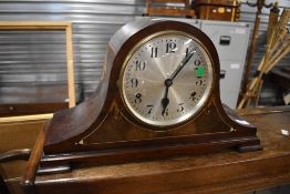 An early 20th Century mahogany mantel clock in napoleon style