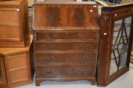 A modern bureau in mahogany with four drawer base