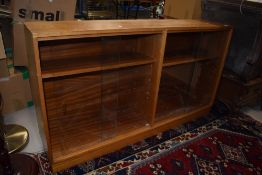 A mid century book case having Sapele frame with glazed doors